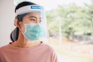 woman wearing face mask and face shield