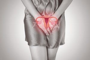 woman holding her pelvic with image of reproductive organs