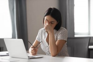 woman stressed infront of work on her laptop