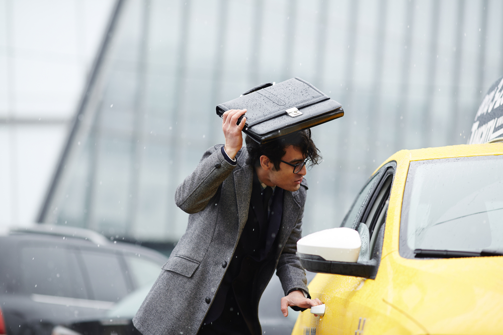 man opening a taxi door