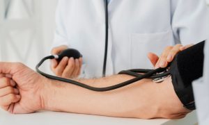 doctor checking blood pressure