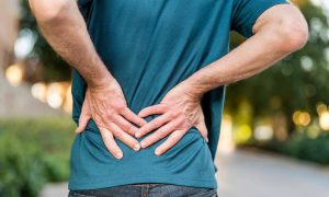 man holding his back